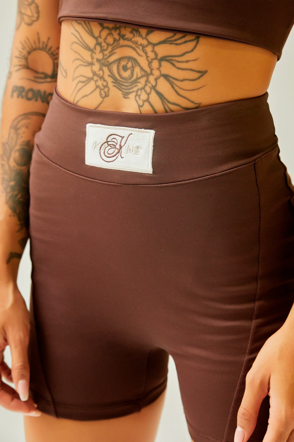 Biker deportivo chocolate con cortes y aplique Kavans